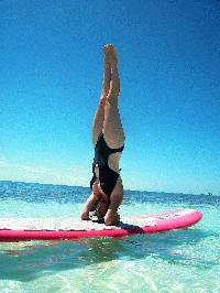 Jennie Pawlowsky doing a headstand on her Stand up Paddleboard